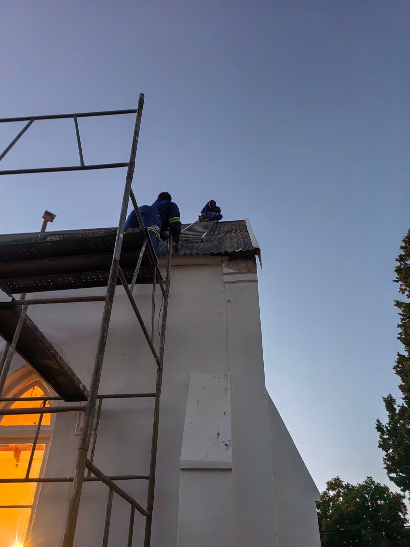 Working on the church at dusk
